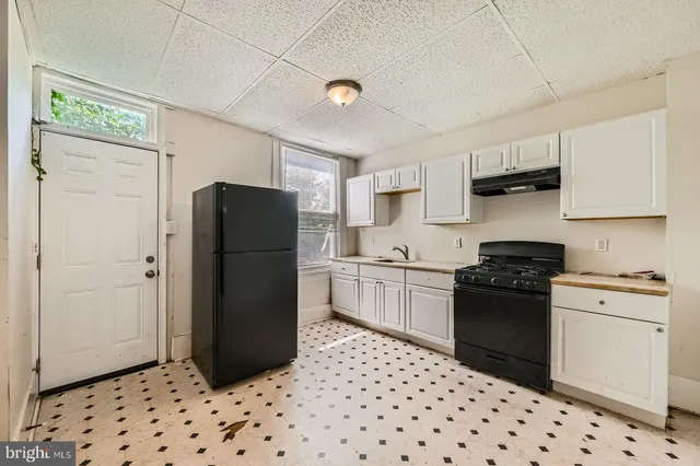 a kitchen with a refrigerator and a stove