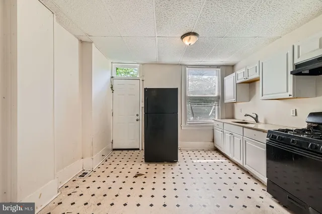 a kitchen with a refrigerator and a stove