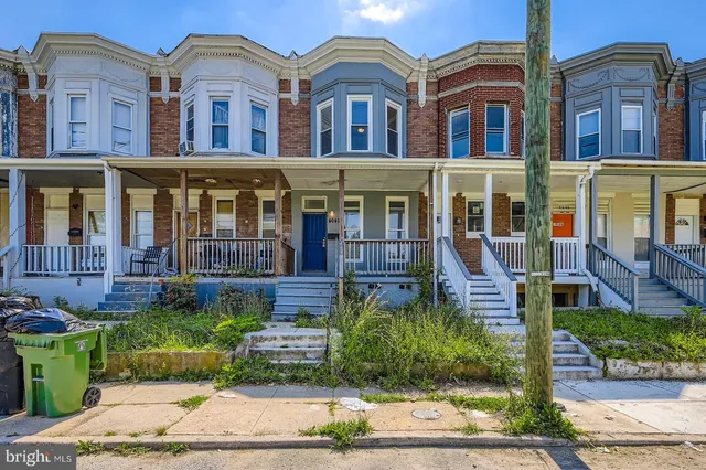 a front view of a residential apartment building with a yard