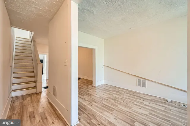 a view of hallway with wooden floor