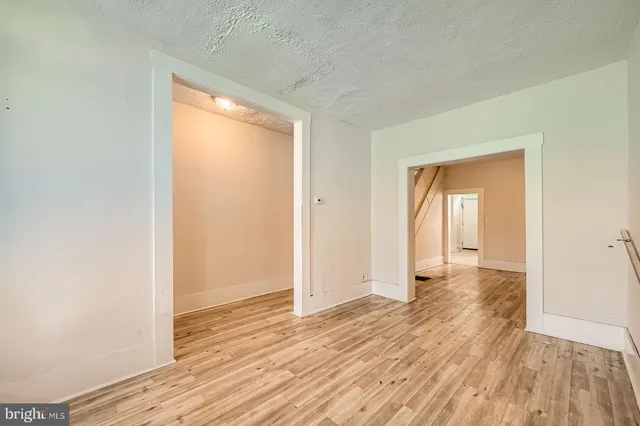 a view of a room with wooden floor and a window