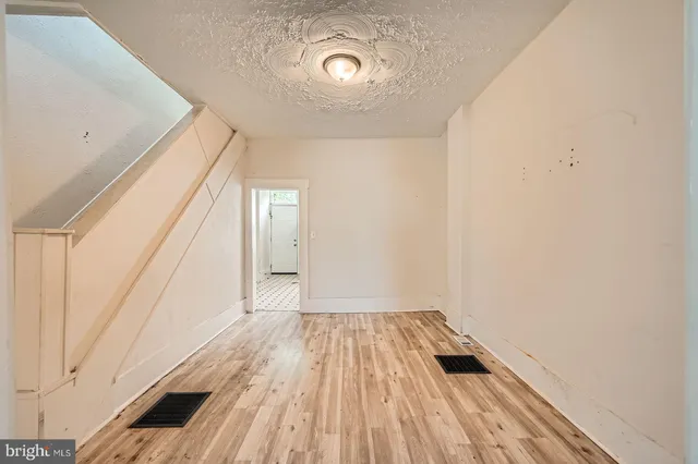 a view of a room with wooden floor and brick walls