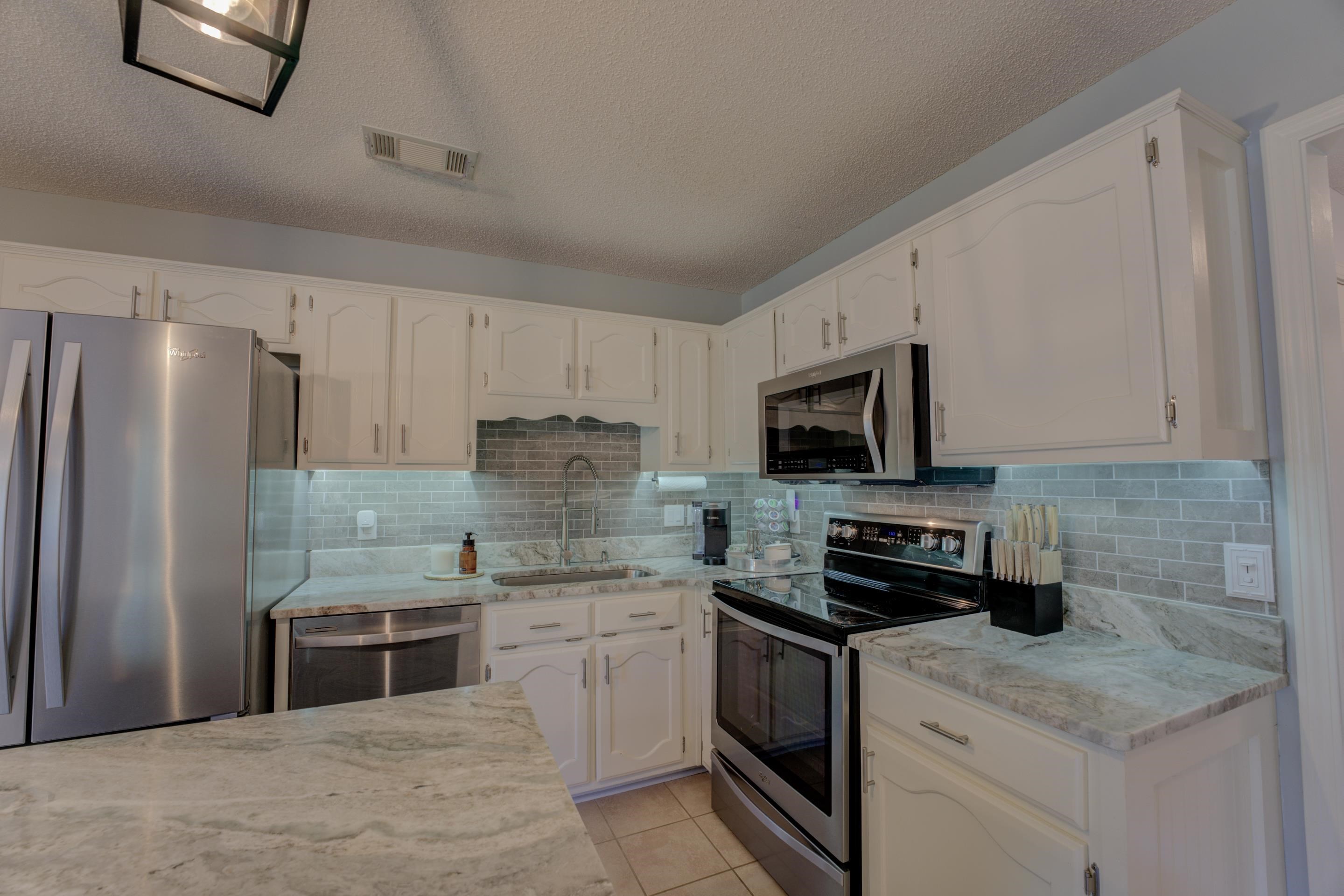 1515 Wolf Pack Drive Collierville, TN 38017 - Photo 11 of 28 a kitchen with stainless steel appliances granite countertop a stove a sink and a refrigerator