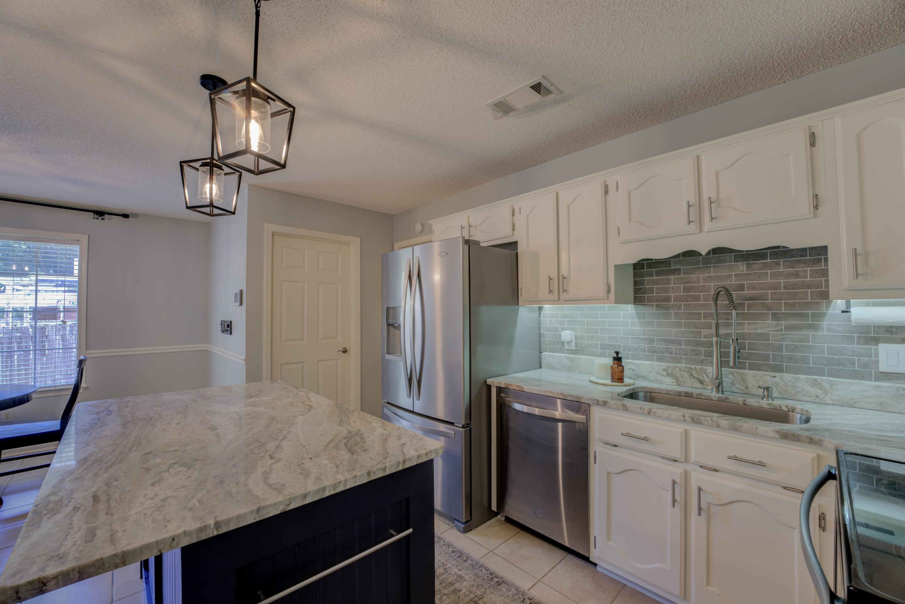 1515 Wolf Pack Drive Collierville, TN 38017 - Photo 12 of 28 a kitchen with a sink dishwasher a stove a refrigerator and cabinets