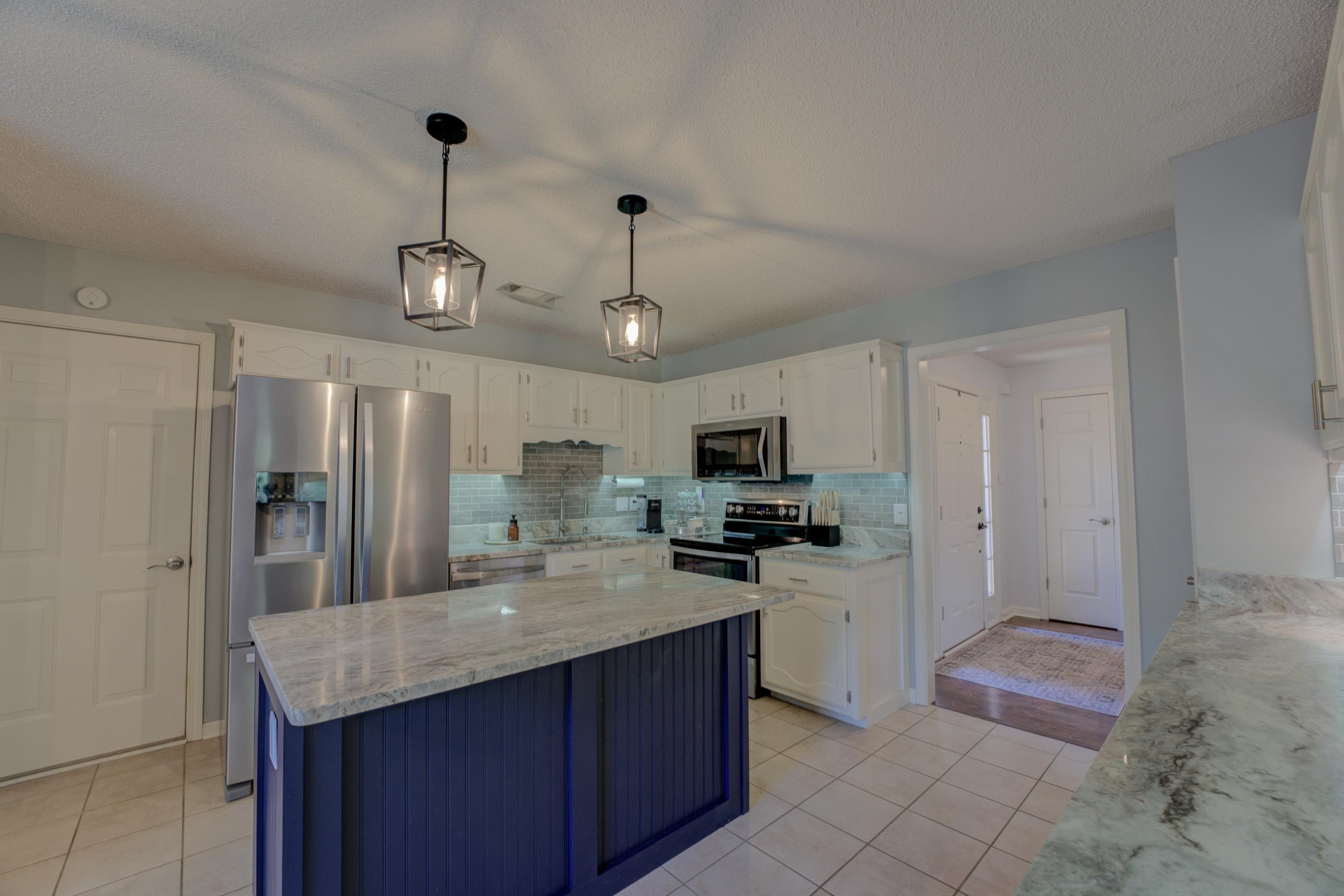 1515 Wolf Pack Drive Collierville, TN 38017 - Photo 13 of 28 a kitchen with kitchen island granite countertop stainless steel appliances a sink a counter top space cabinets and stainless steel appliances
