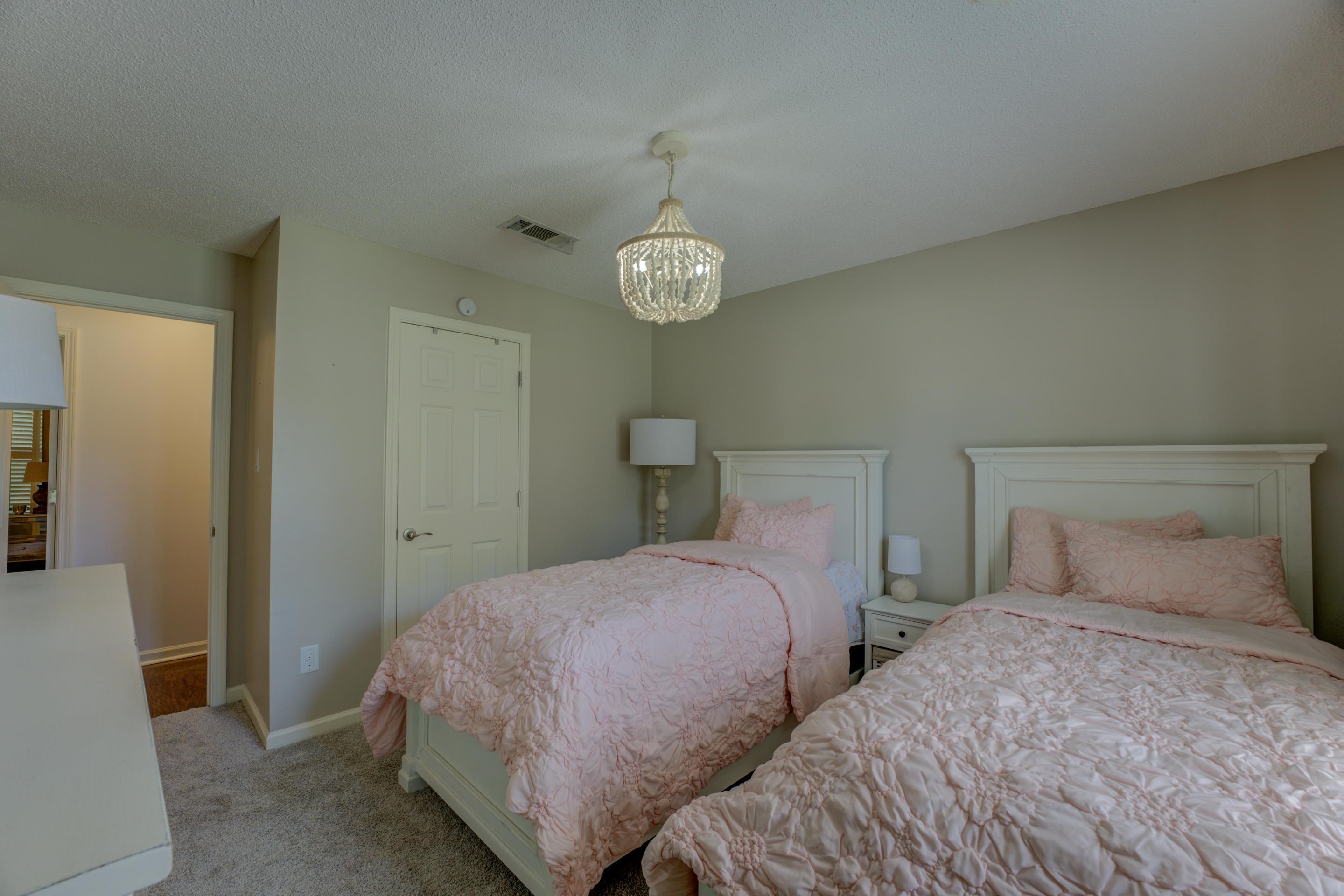 1515 Wolf Pack Drive Collierville, TN 38017 - Photo 18 of 28 a bedroom with two beds and a lamp on table