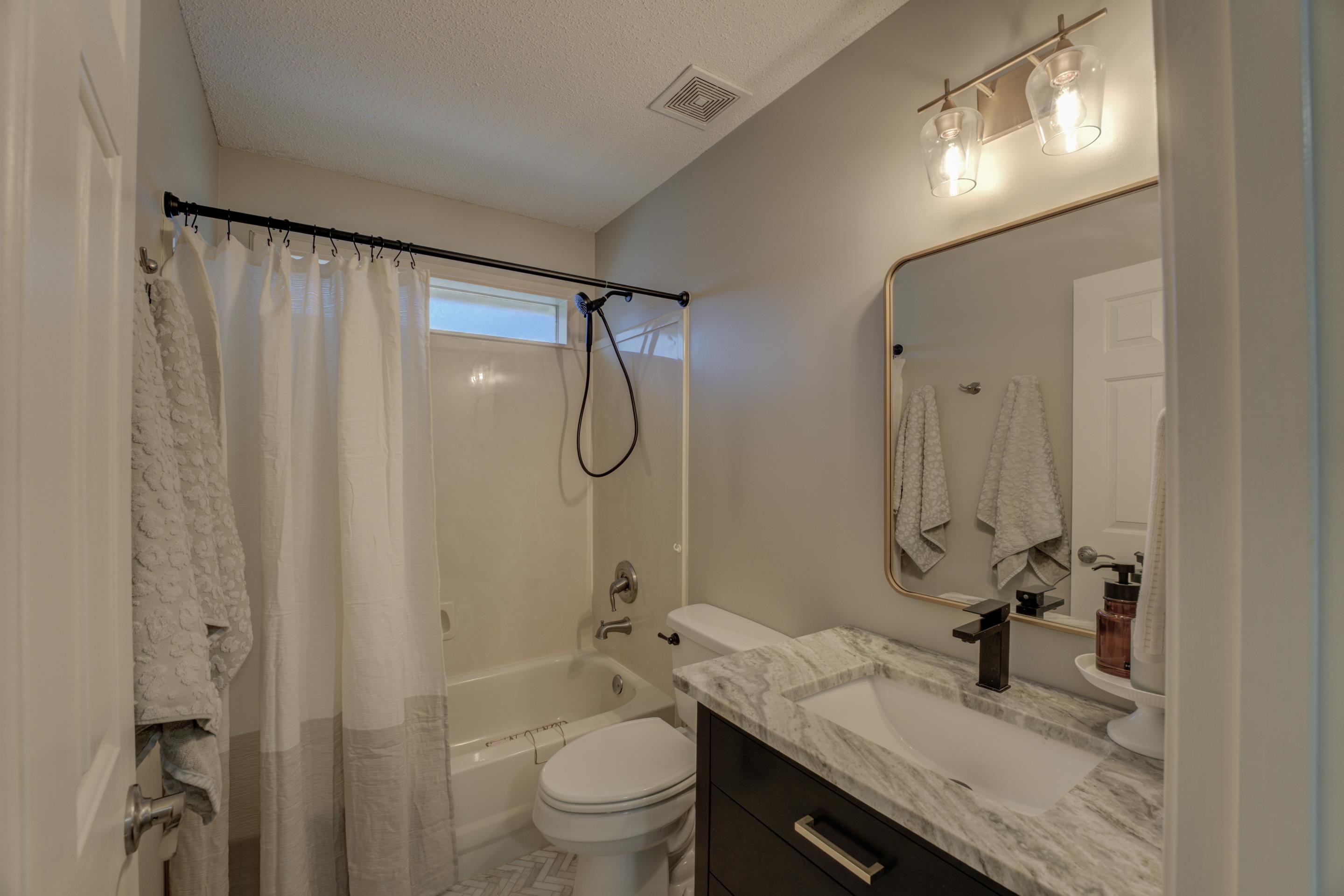 1515 Wolf Pack Drive Collierville, TN 38017 - Photo 19 of 28 a bathroom with a granite countertop sink toilet and shower