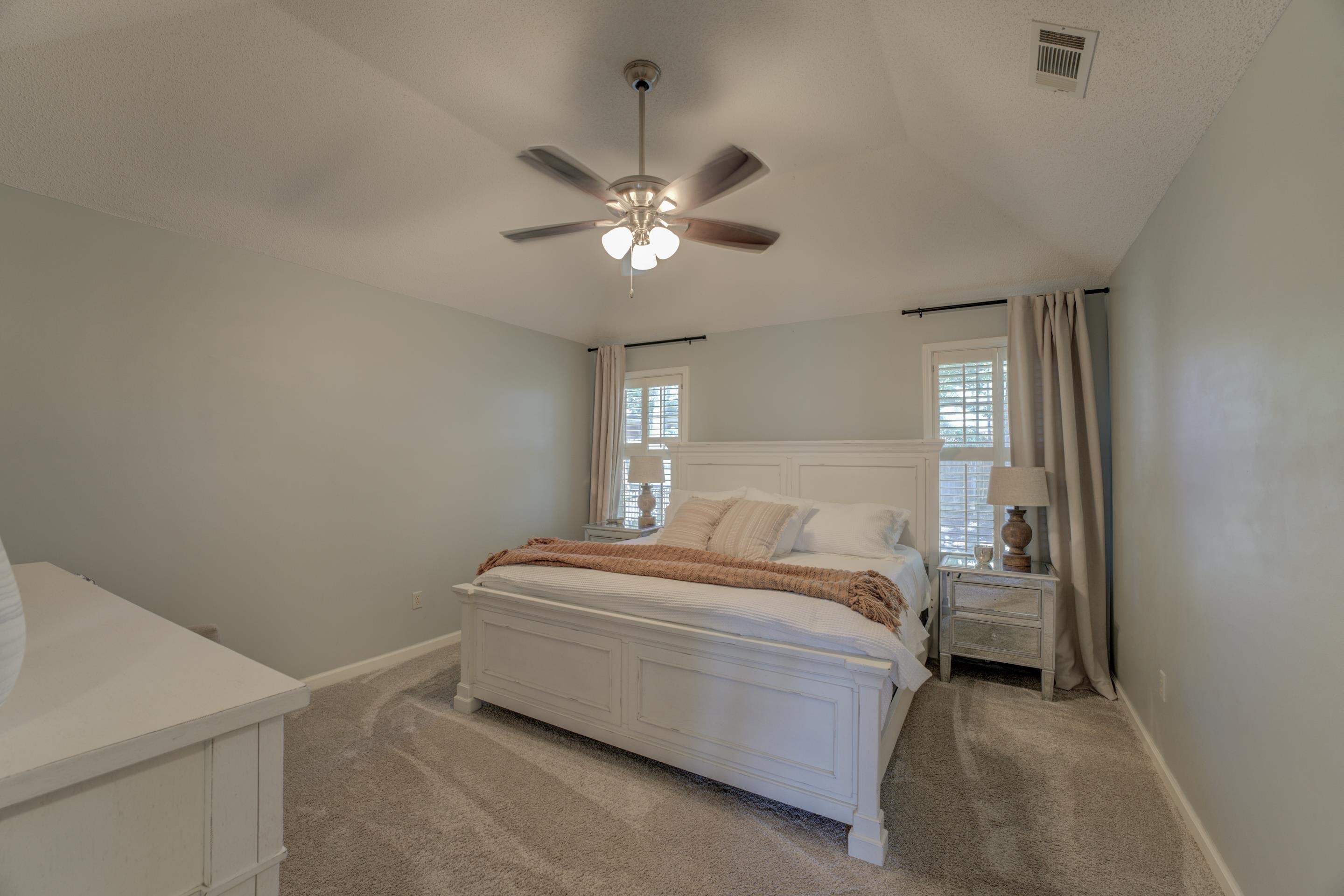1515 Wolf Pack Drive Collierville, TN 38017 - Photo 21 of 28 a bedroom with a bed and a ceiling fan
