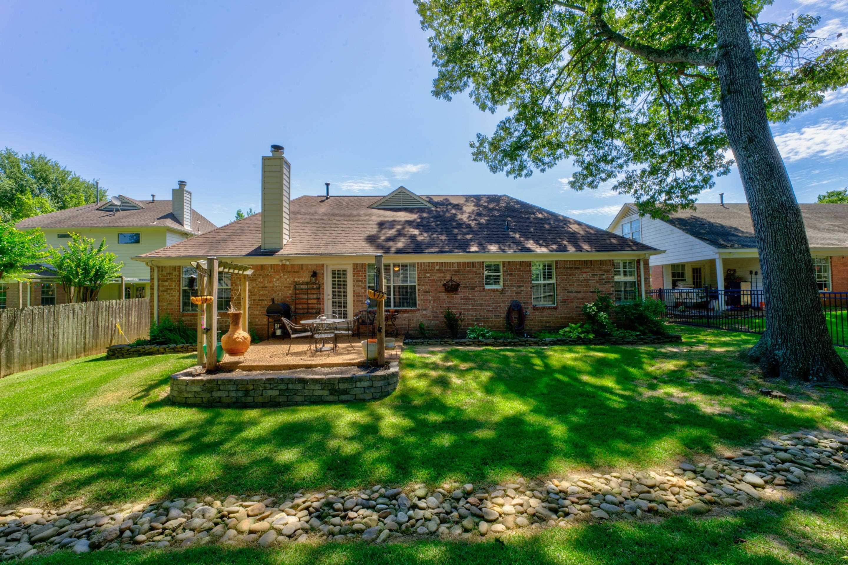 1515 Wolf Pack Drive Collierville, TN 38017 - Photo 28 of 28 a front view of a house with a garden and sitting area