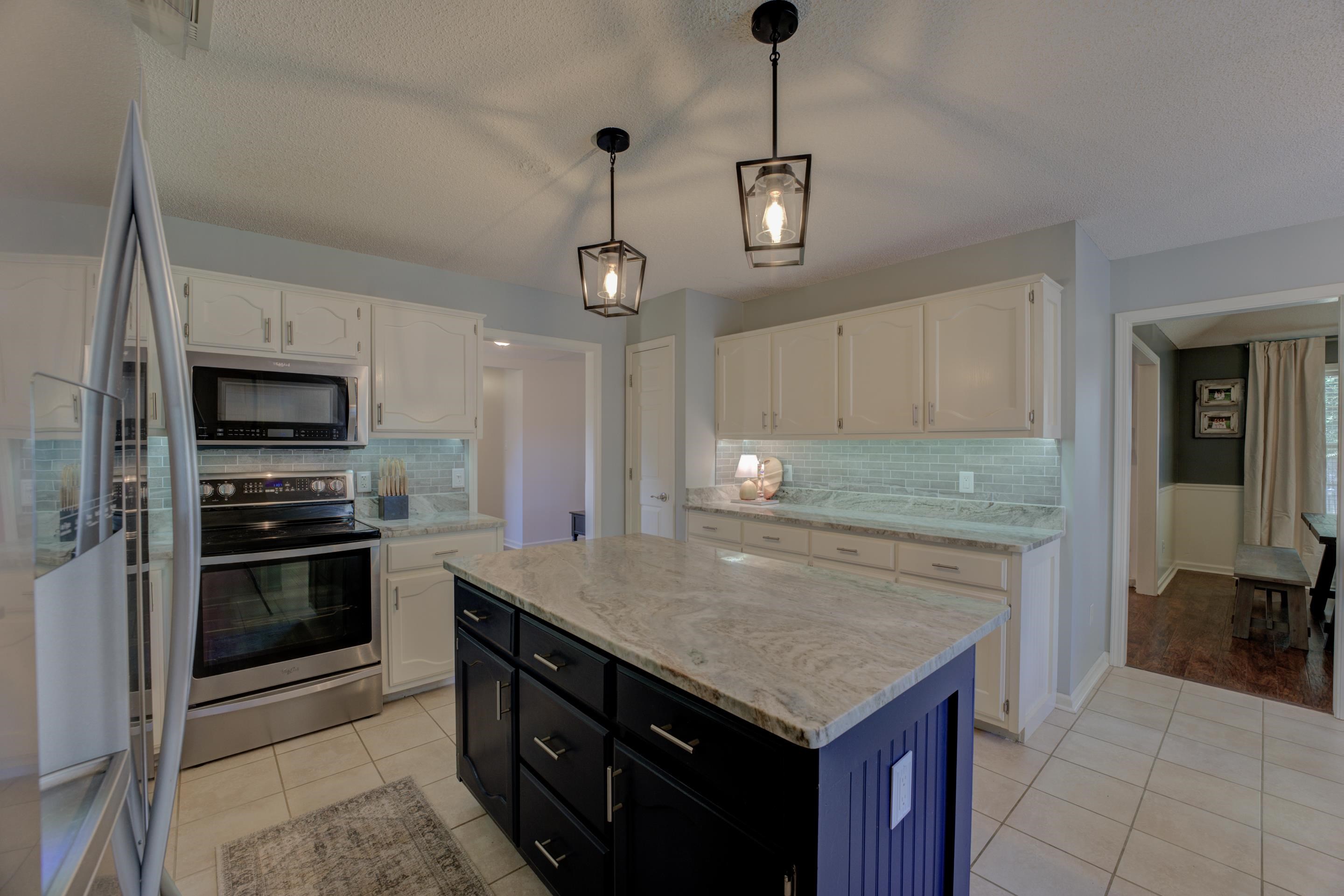 1515 Wolf Pack Drive Collierville, TN 38017 - Photo 9 of 28 a kitchen with kitchen island a counter space a sink and stainless steel appliances