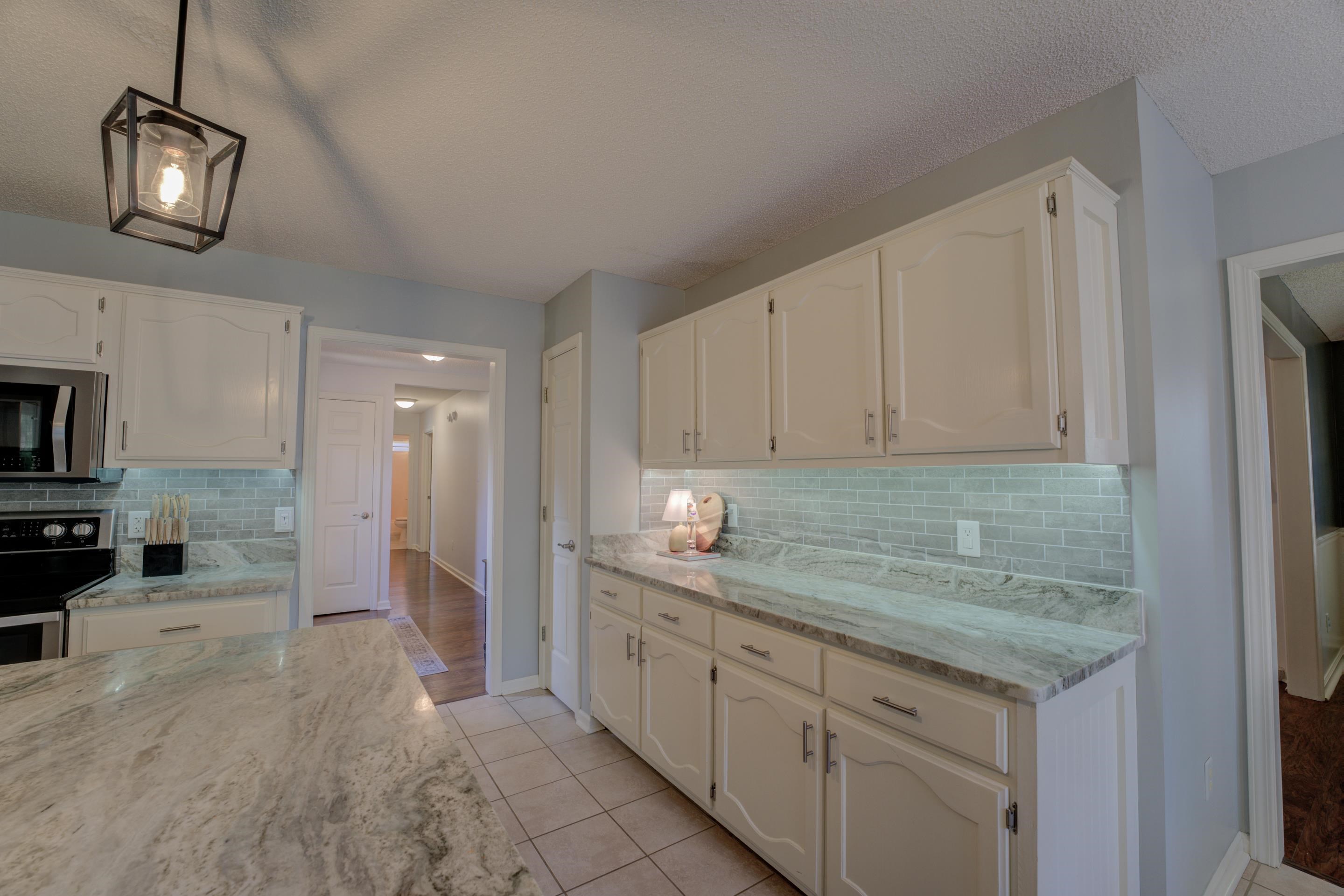 1515 Wolf Pack Drive Collierville, TN 38017 - Photo 10 of 28 a kitchen with granite countertop a sink and a stove top oven