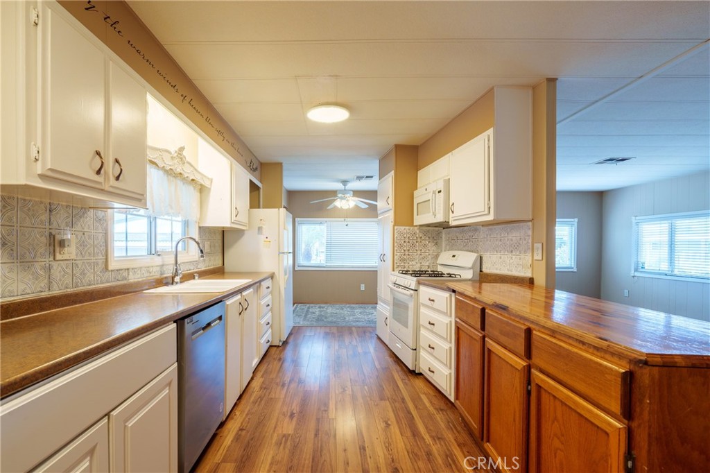 4000 Pierce Street, Unit 72 Riverside, CA 92505 - Photo 3 of 20 a large kitchen with stainless steel appliances granite countertop a lot of counter space and wooden floors
