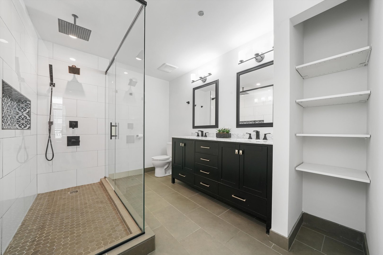 520 South State Street, Unit 503 Chicago, IL 60605 - Photo 16 of 25 a bathroom with a double vanity sink toilet and shower