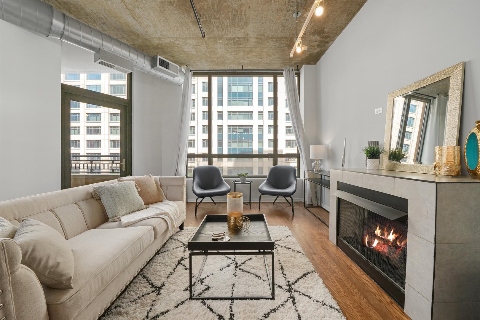 520 South State Street, Unit 503 Chicago, IL 60605 - Photo 4 of 25 a living room with furniture a large window and a fireplace