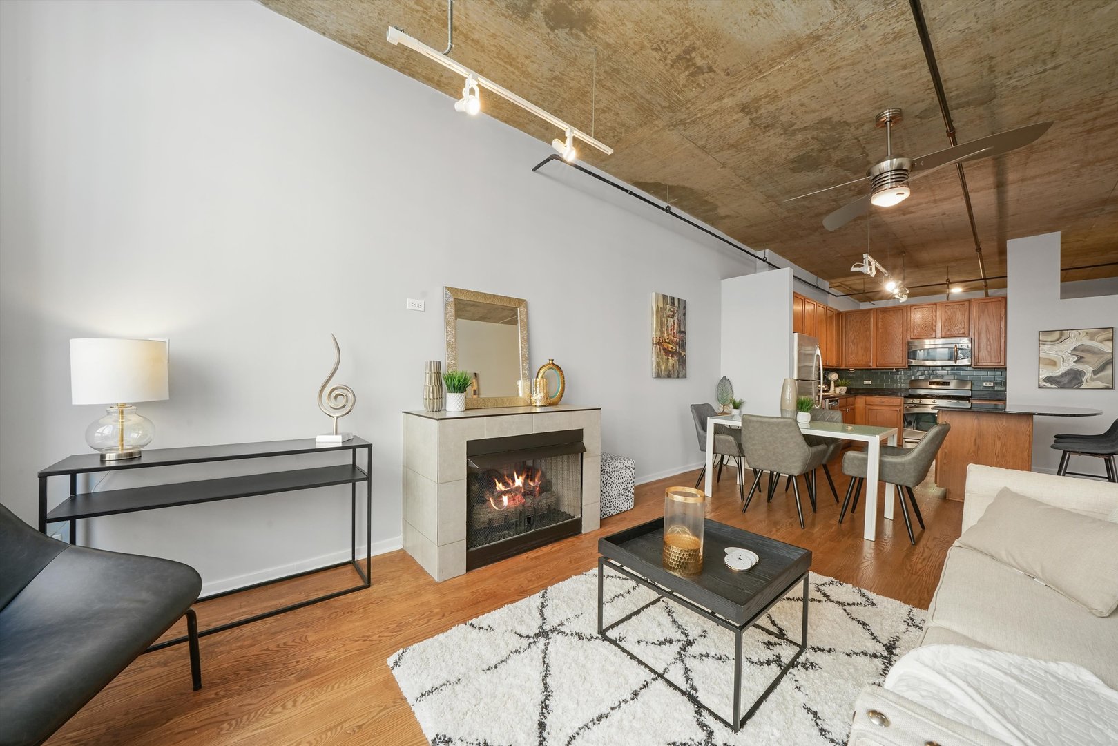 520 South State Street, Unit 503 Chicago, IL 60605 - Photo 5 of 25 a living room with furniture a table and a fireplace