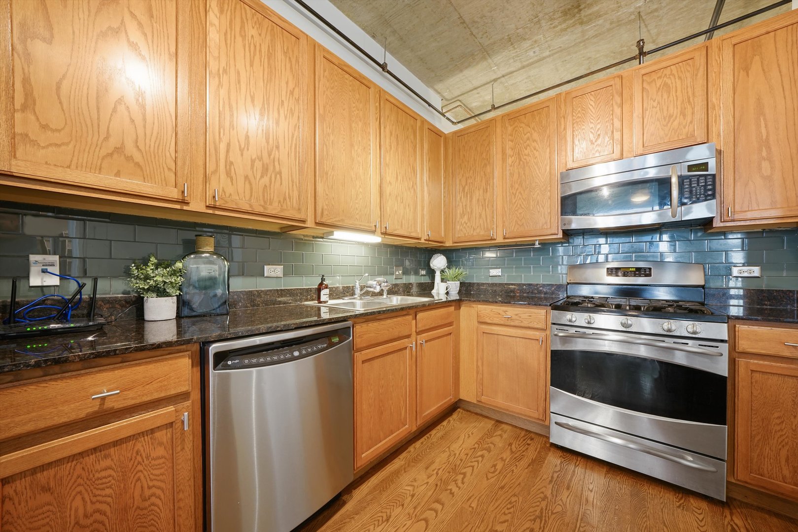 520 South State Street, Unit 503 Chicago, IL 60605 - Photo 8 of 25 a kitchen with stainless steel appliances granite countertop a sink a stove and cabinets