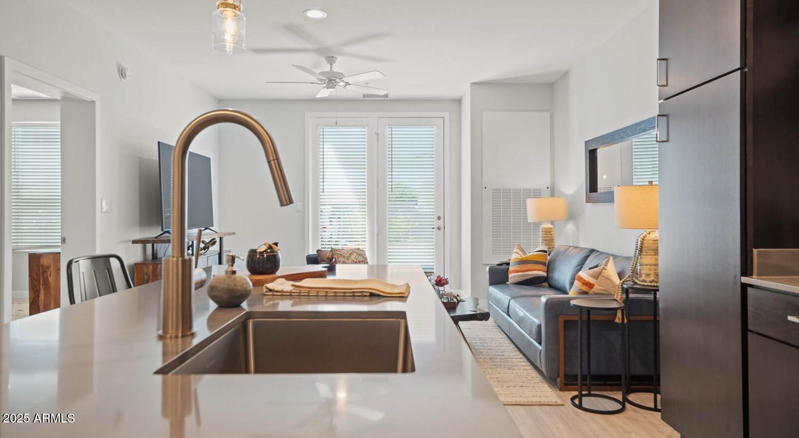 6025 West Thomas Road, Unit 1 Phoenix, AZ 85033 - Photo 5 of 26 a living room with furniture and a chandelier