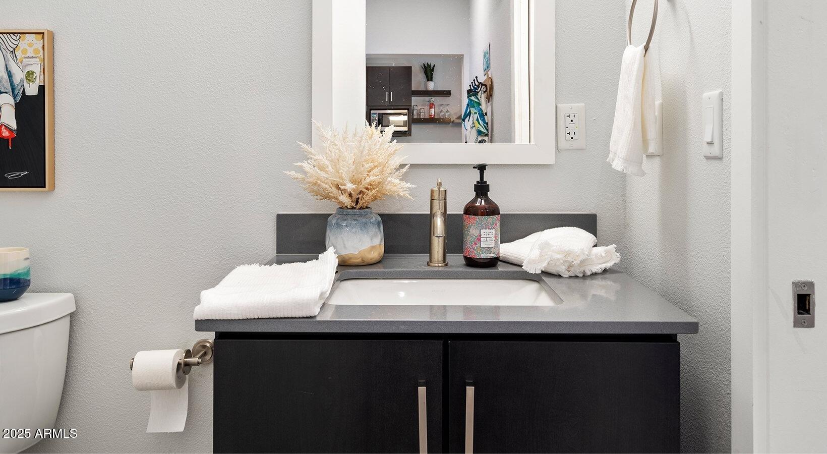 6025 West Thomas Road, Unit 1 Phoenix, AZ 85033 - Photo 9 of 26 a bathroom with a sink and a mirror