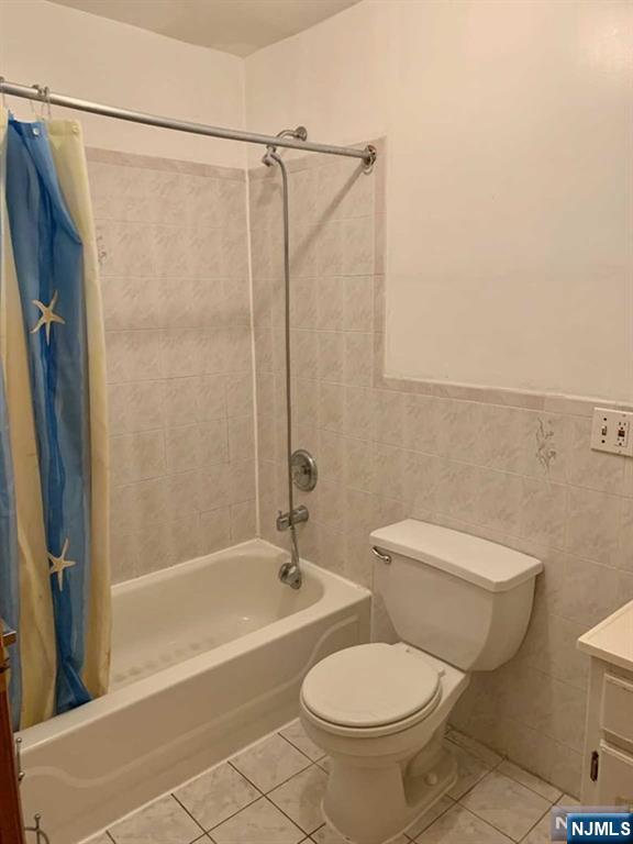 422 A Warren Street, Unit 1F Harrison, NJ 07029 - Photo 11 of 11 a white toilet sitting next to a bath tub