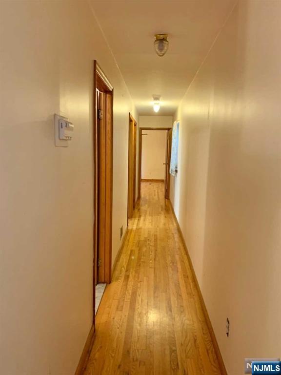 422 A Warren Street, Unit 1F Harrison, NJ 07029 - Photo 3 of 11 a view of gallery with wooden floor
