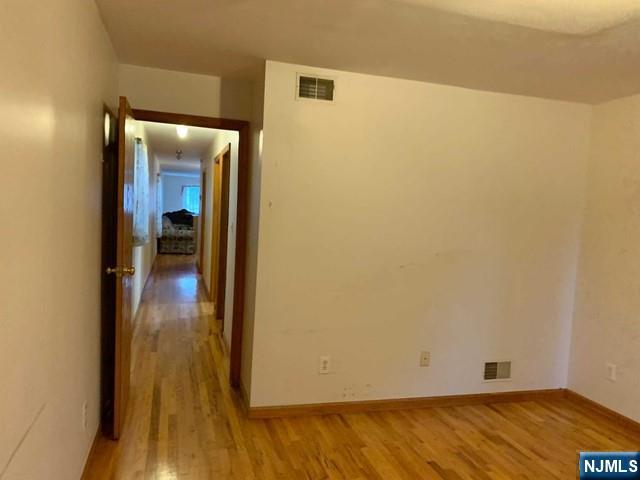422 A Warren Street, Unit 1F Harrison, NJ 07029 - Photo 7 of 11 a view of a room with wooden floor and a hallway