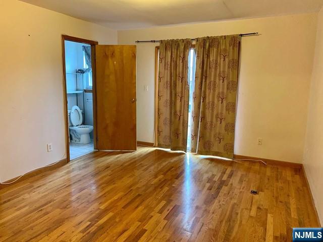 422 A Warren Street, Unit 1F Harrison, NJ 07029 - Photo 9 of 11 a view of an empty room with wooden floor