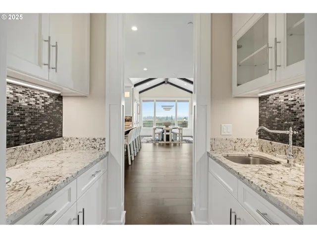a kitchen with granite countertop a sink and cabinets
