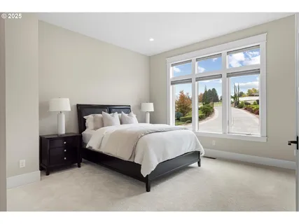 a bedroom with a bed lamp and window