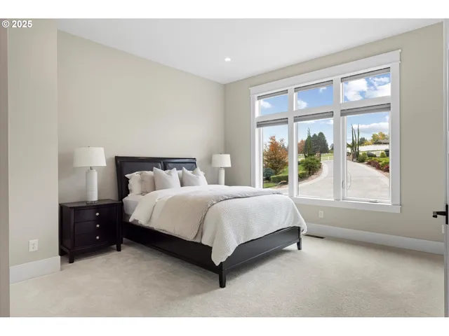 a bedroom with a bed lamp and window