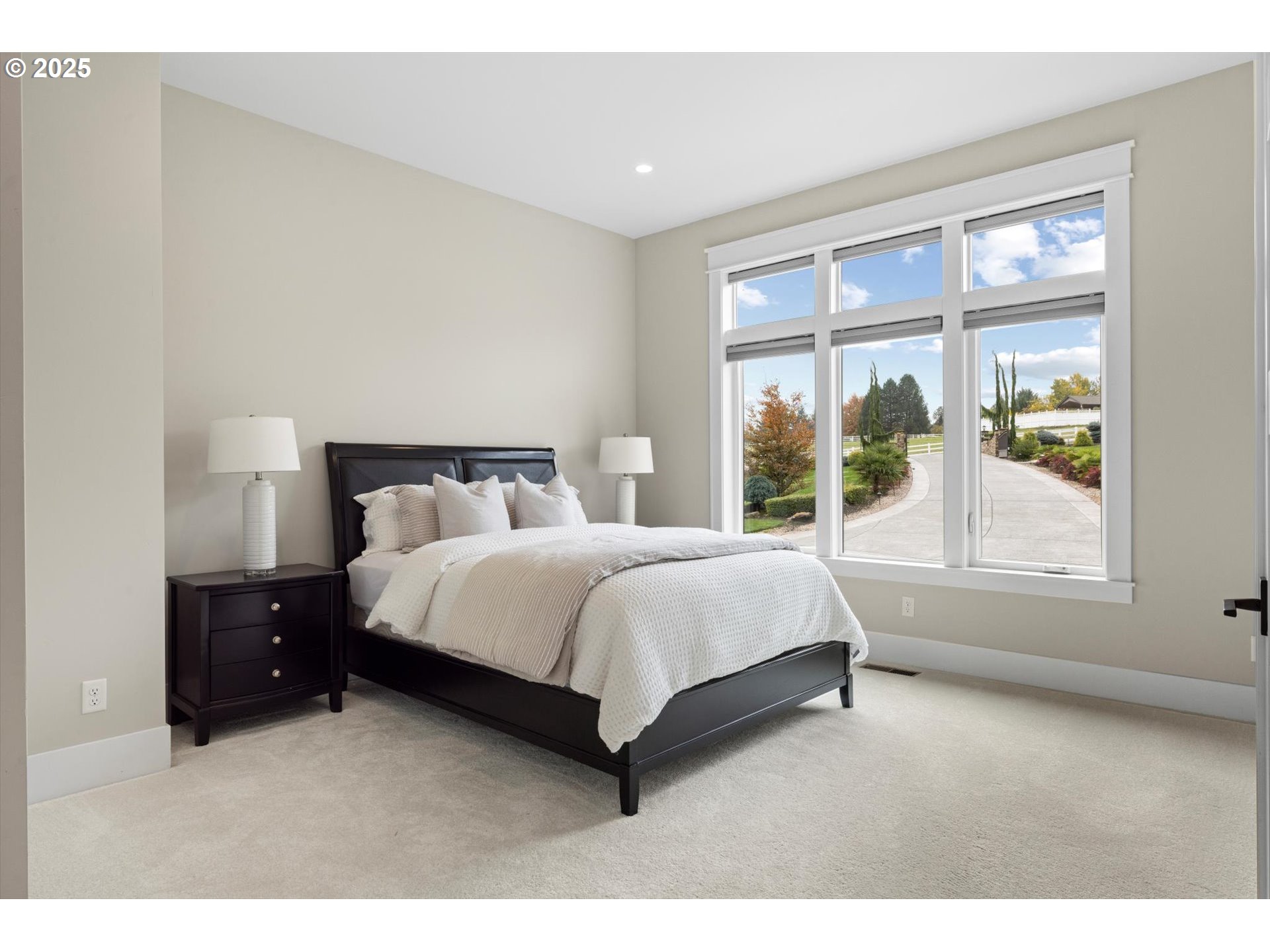 900 Northwest 216th Circle Ridgefield, WA 98642 - Photo 14 of 47 a bedroom with a bed lamp and window