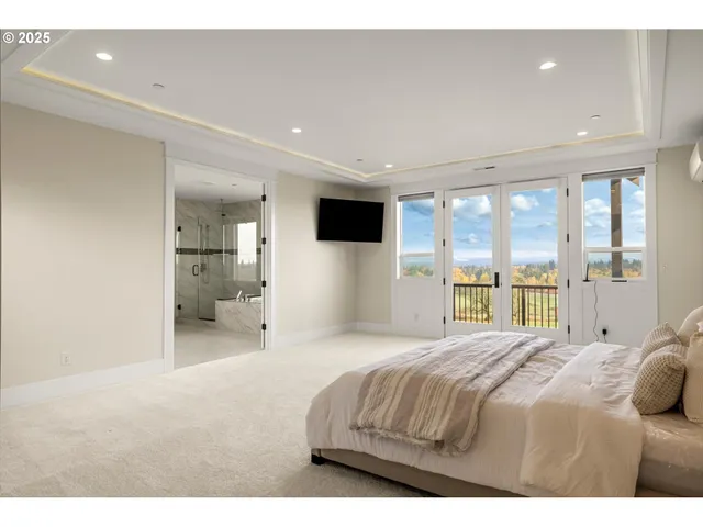 a bedroom with a bed and a large window