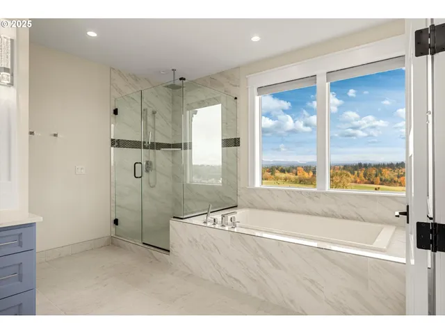 a bathroom with a bathtub and a shower