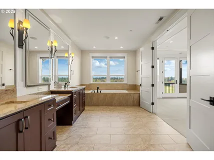 a large kitchen with stainless steel appliances kitchen island granite countertop a large counter top and a view of living room
