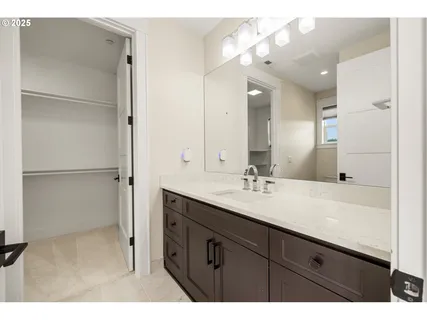 a bathroom with a sink vanity granite and a mirror