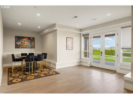 a view of a work space with wooden floor and windows