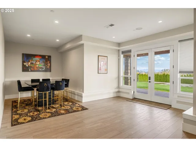 a view of a work space with wooden floor and windows