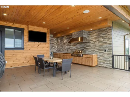 a balcony with table and chairs