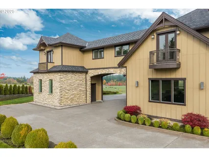a front view of a house with a garden