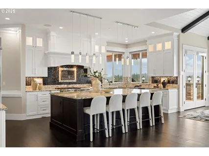 a large kitchen with a table and chairs