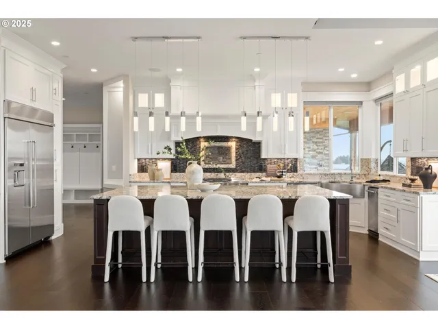 a large kitchen with a table and chairs