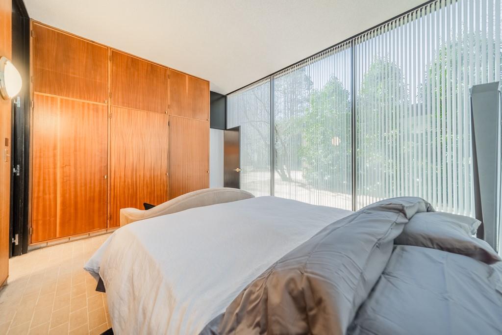 9331 Providence Road Charlotte, NC 28270 - Photo 24 of 39 a bedroom with a large window and a bed