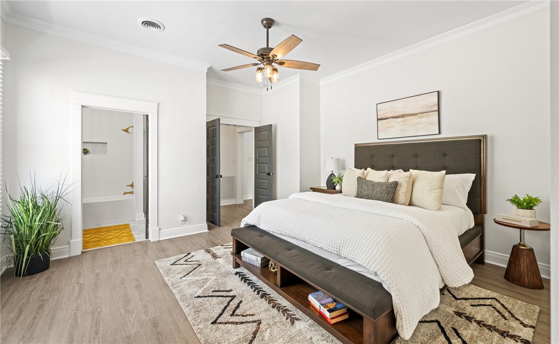 514 West 4th Street Sinton, TX 78387 - Photo 15 of 32 a bedroom with a bed and a chandelier