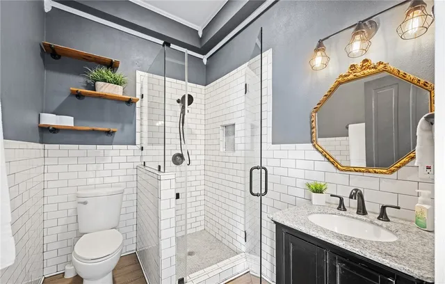 a bathroom with a granite countertop sink mirror and toilet