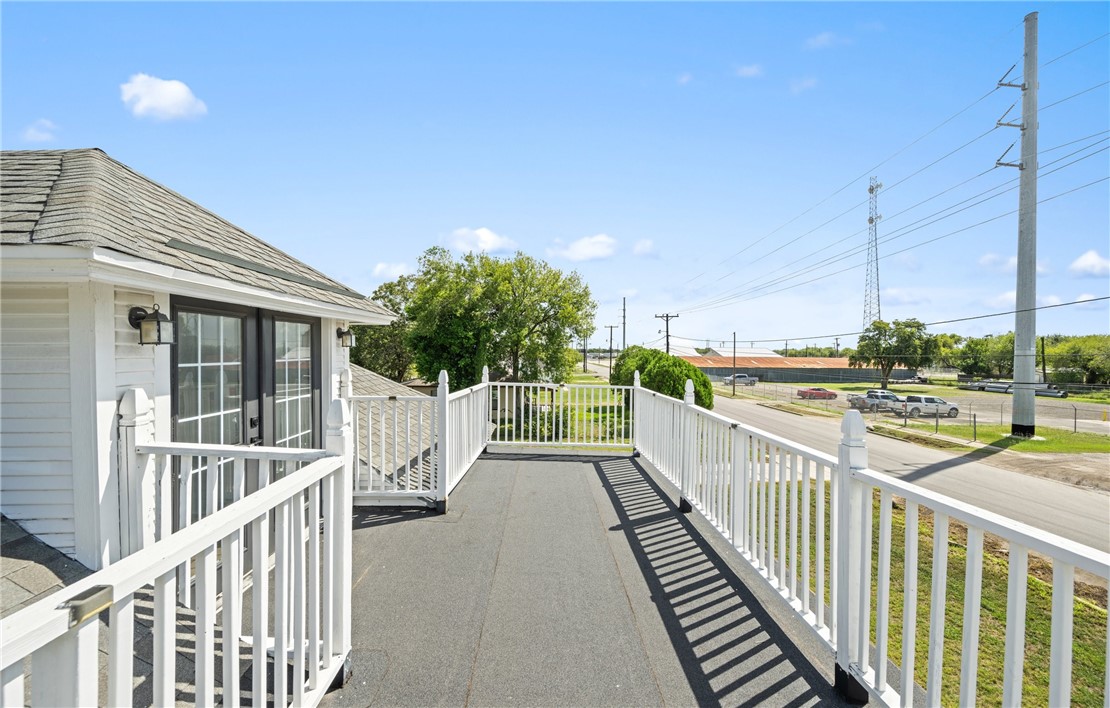 514 West 4th Street Sinton, TX 78387 - Photo 21 of 32 a view of a balcony with floor to ceiling window and wooden fence