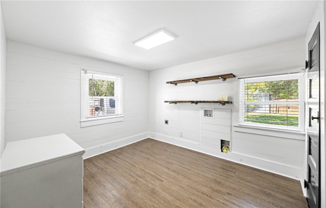 514 West 4th Street Sinton, TX 78387 - Photo 22 of 32 an empty room with wooden floor and windows