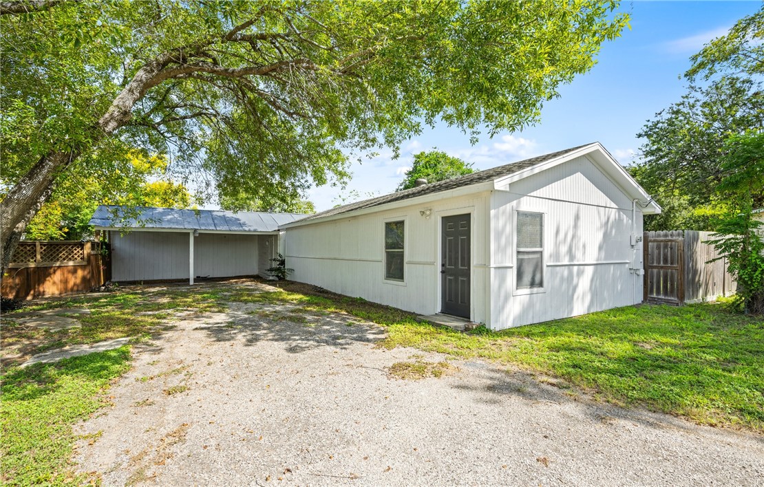 514 West 4th Street Sinton, TX 78387 - Photo 27 of 32 a view of a yard with a house and a large tree
