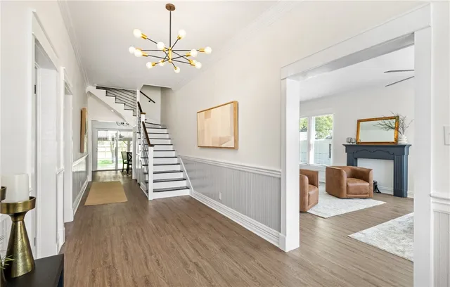 a view of a livingroom with wooden floor and furniture