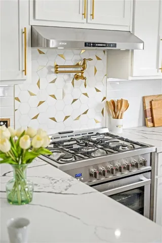 a view of kitchen appliances and cabinets