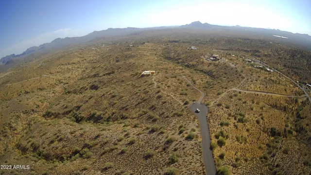 a view of a large mountain with a mountain in the background