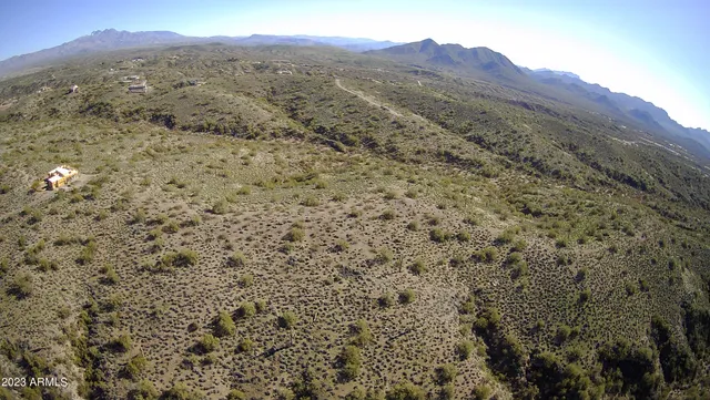 a view of a lush green hillside and a building
